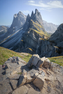 La Seceda nelle Dolomiti illuminata dalla luce intensa del mezzogiorno. Le pareti rocciose mostrano forme austere e severe, mentre il profilo della montagna emerge netto sotto un cielo limpido. Un paesaggio che esprime forza, distanza e rispetto per l